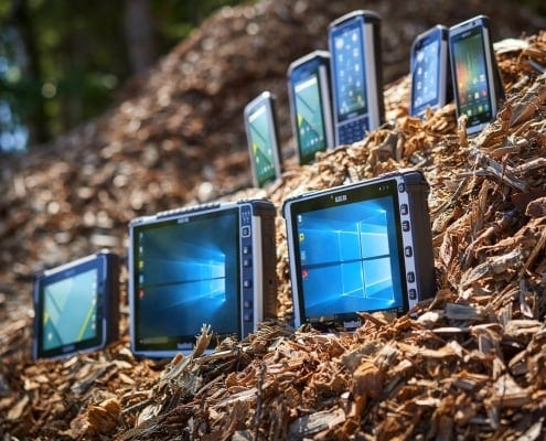 handheld rugged tablets in pile of wood chips