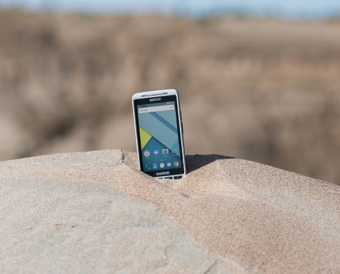 handheld nautiz x2 in pile of sand