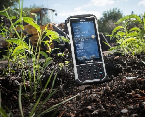 handheld nautiz x8 on ground next to plants